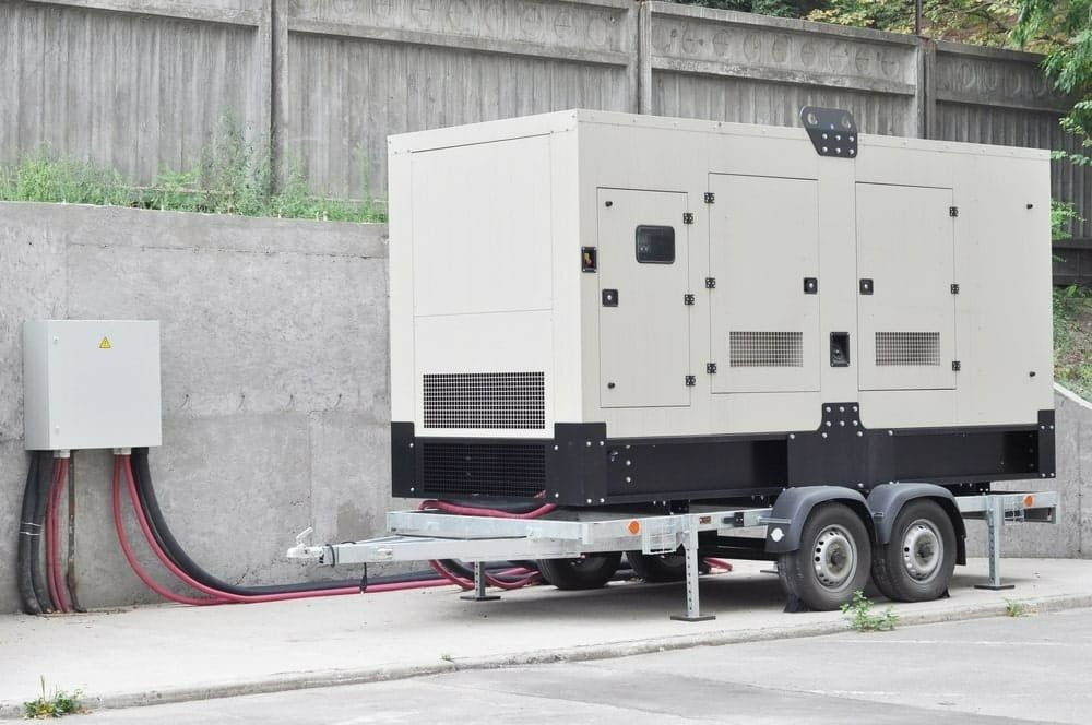 A Generator on a Trailer Next to a Wall, With a Connected Electrical Box — McGrath Electrical & Data in South Grafton, NSW