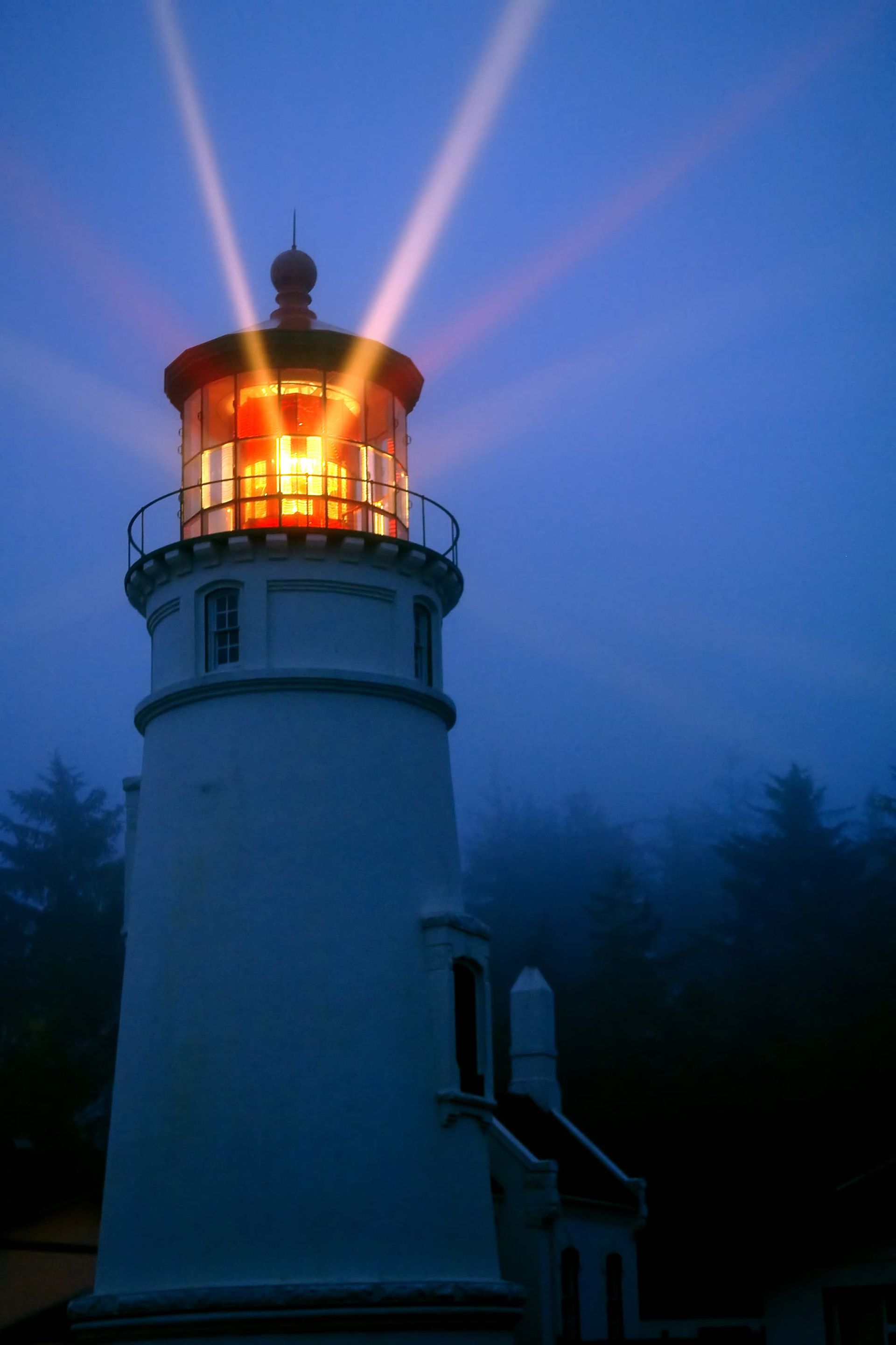 A large white building with a brown roof and a lot of windows.