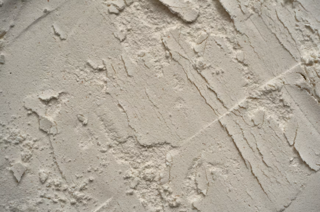 Close-up of textured drywall compound showing a rough decorative finish by a drywall contractor in San Tan Valley, AZ