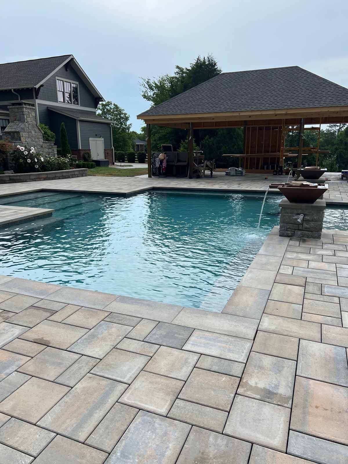 A large swimming pool with a gazebo in the background.