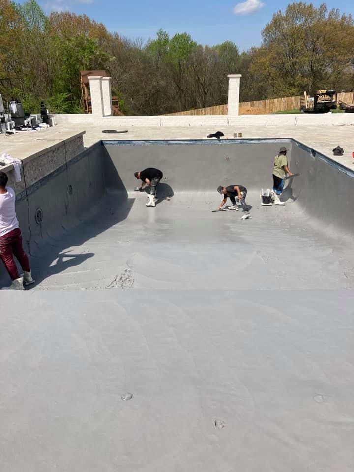 A group of people are working on a swimming pool.