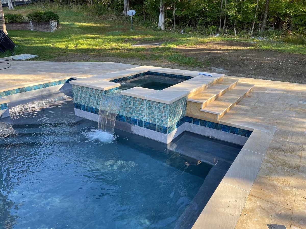 There is a waterfall in the middle of the pool.