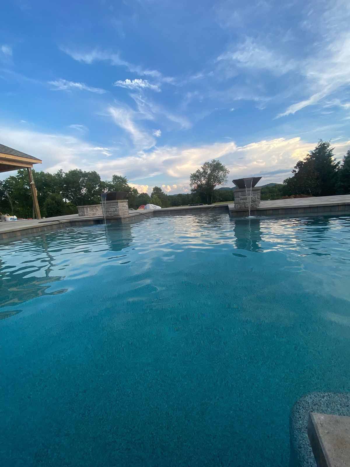 A large swimming pool with a blue sky in the background.