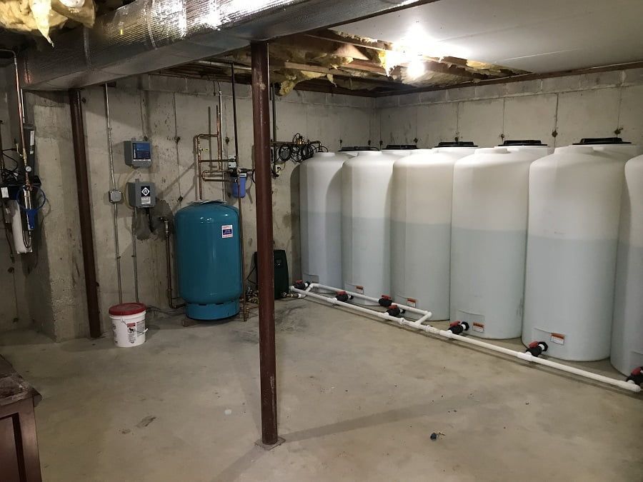 A basement filled with lots of water tanks.