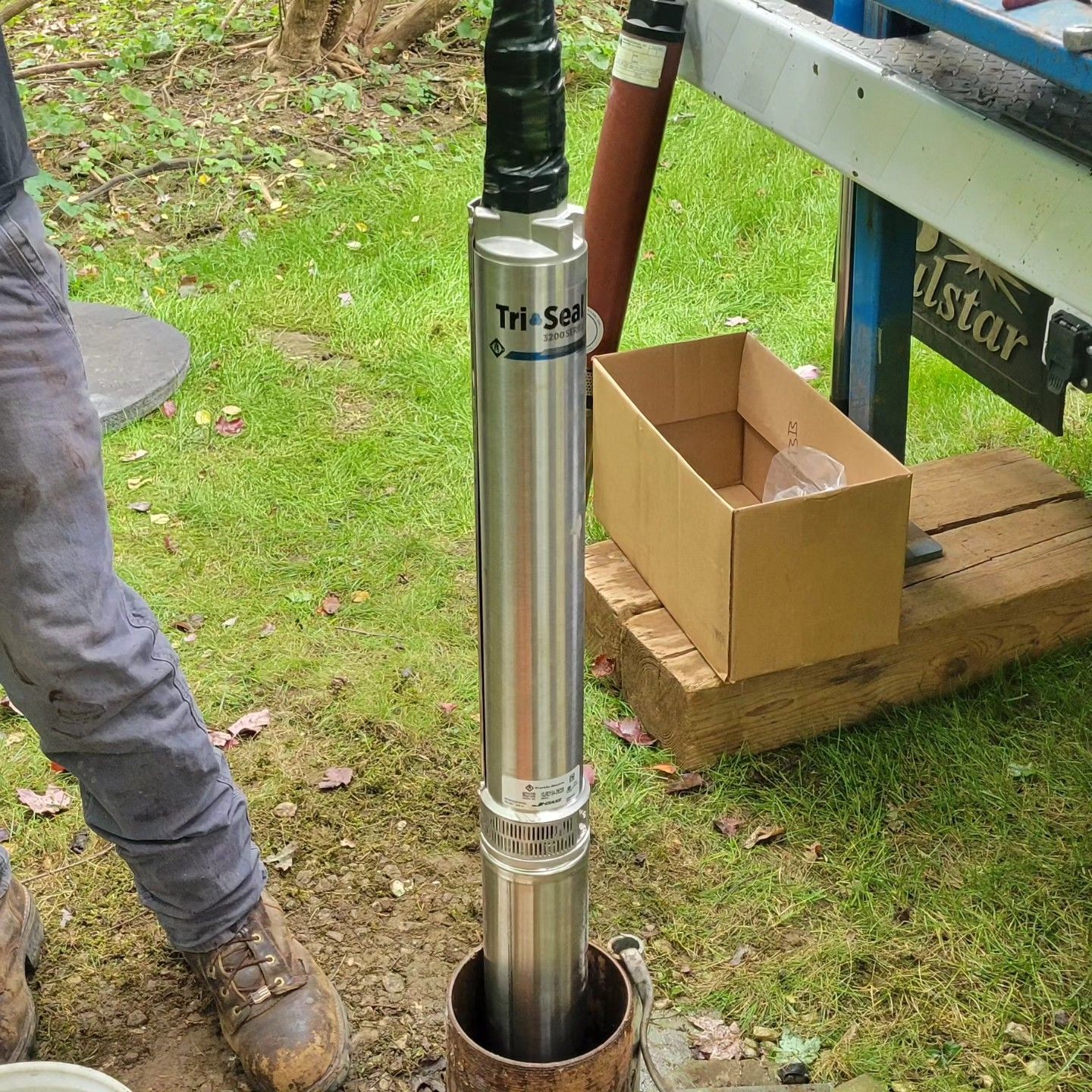 A man is working on a stainless steel water pump