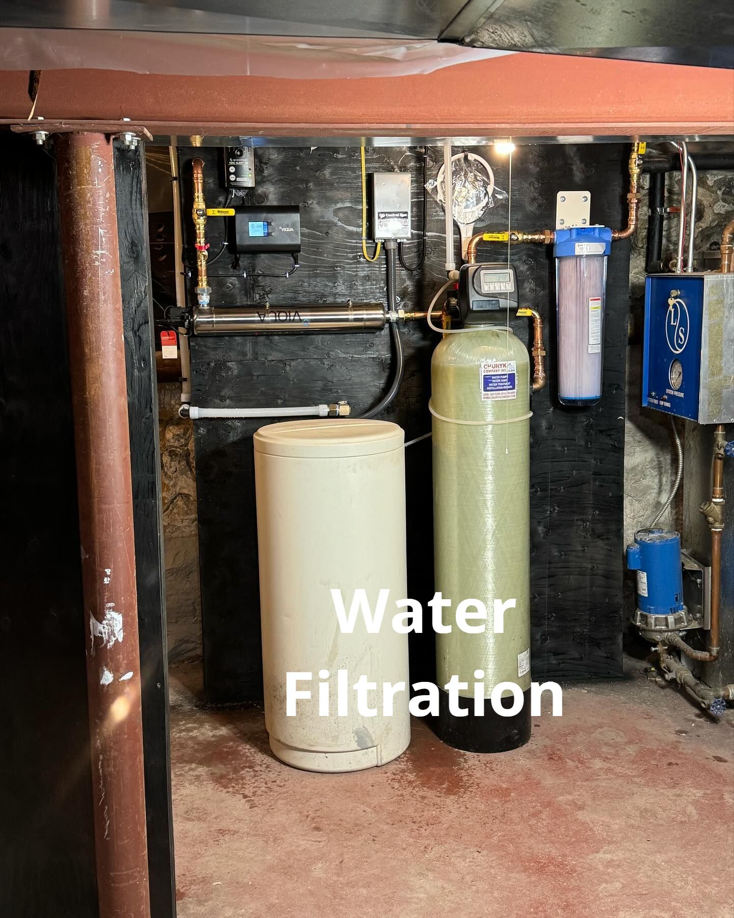 A water filtration system is installed in a basement.