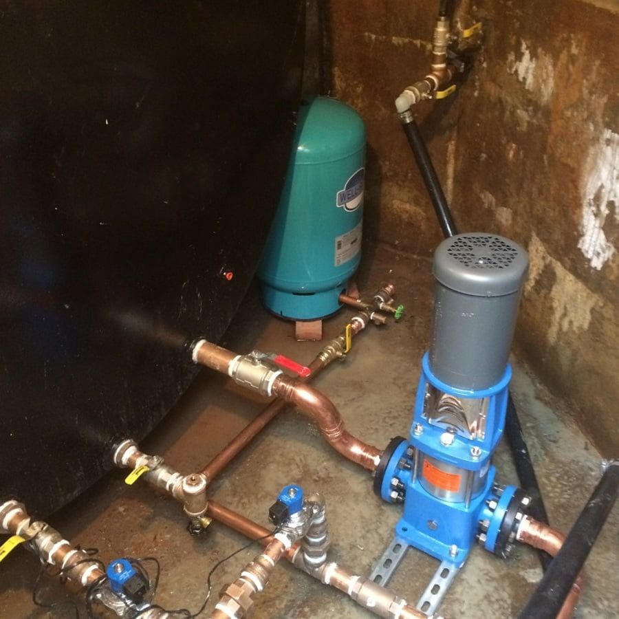 A room with a lot of pipes and a pump