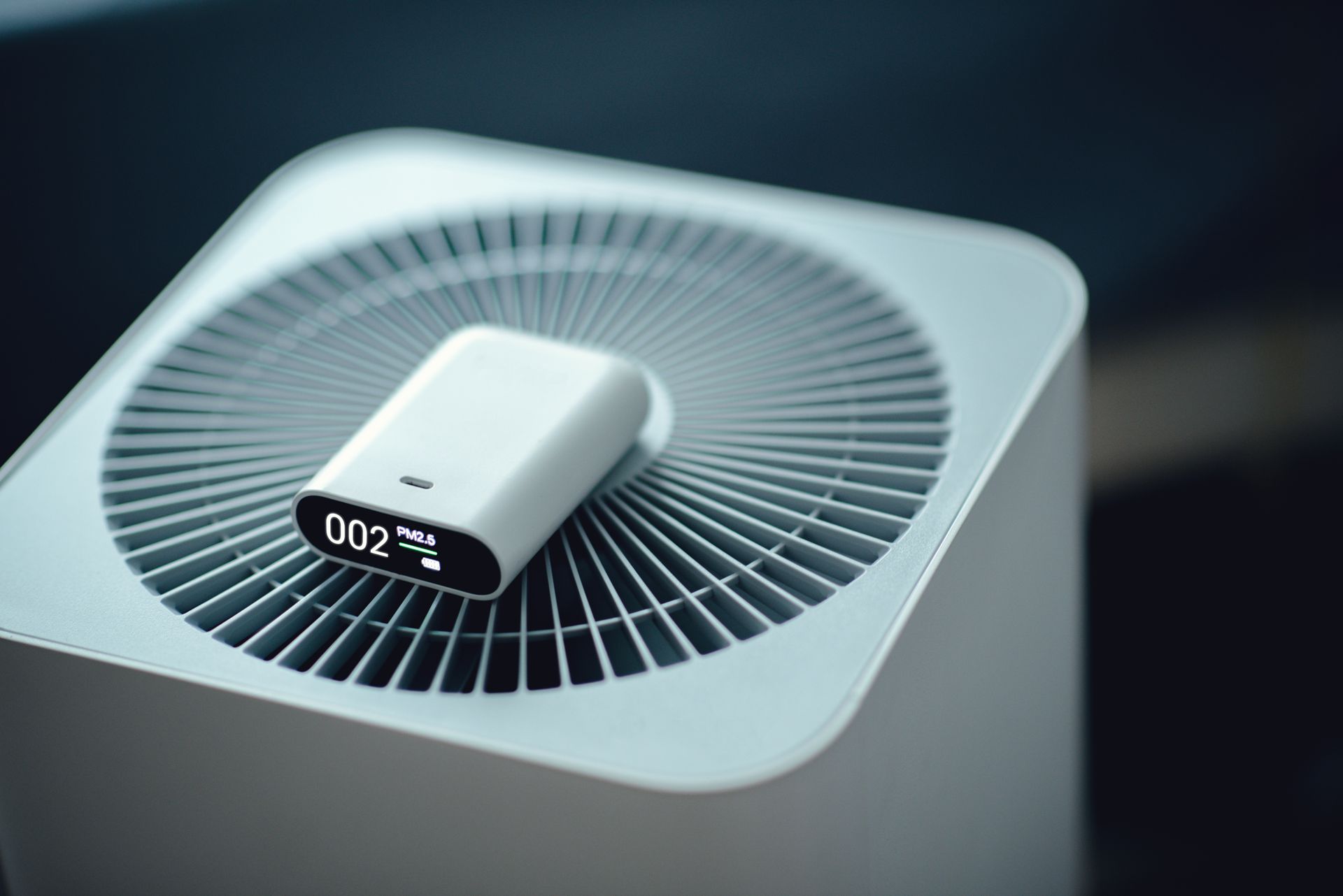 Small white air purifier with digital display on top, viewed from above.