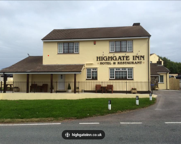 A yellow building with the name highgate inn on it