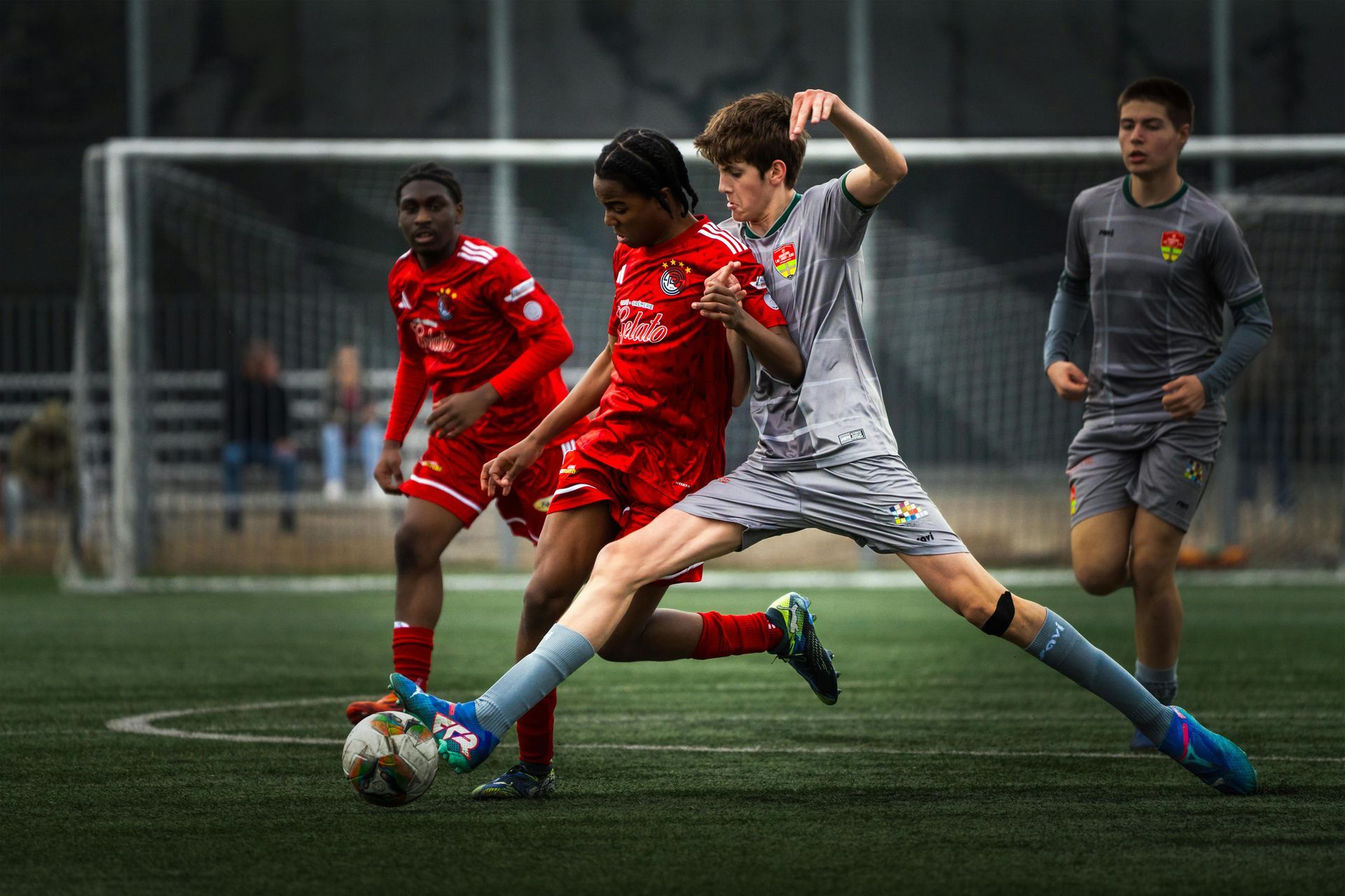 A group of young men are playing soccer on a field.
