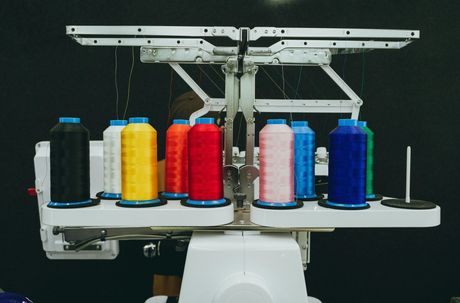 A machine with many spools of thread on it