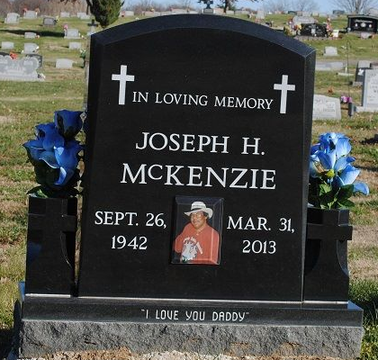 black upright monument with photo and vases