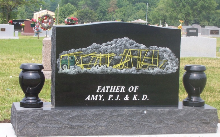 engraved headstone with vases