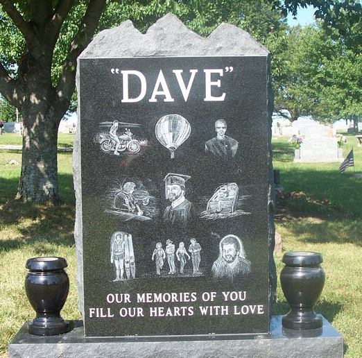 engraved black headstone with vases