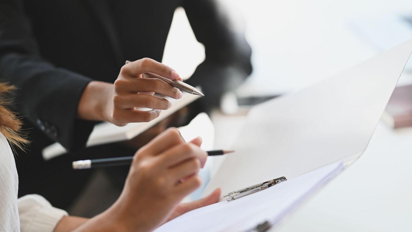 Two women reviewing practice paperwork together