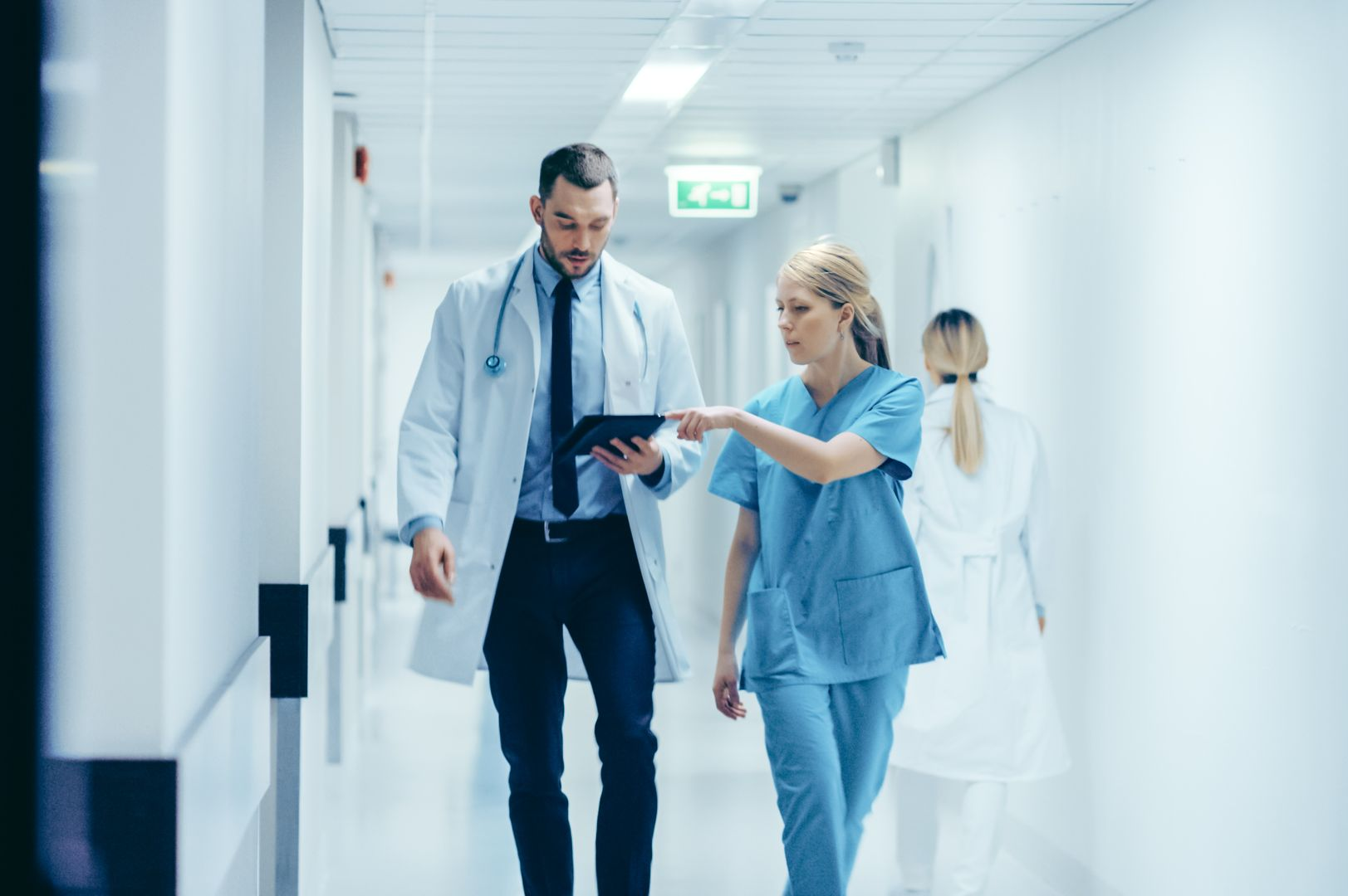 nurse and doctor walking down hospital corridor