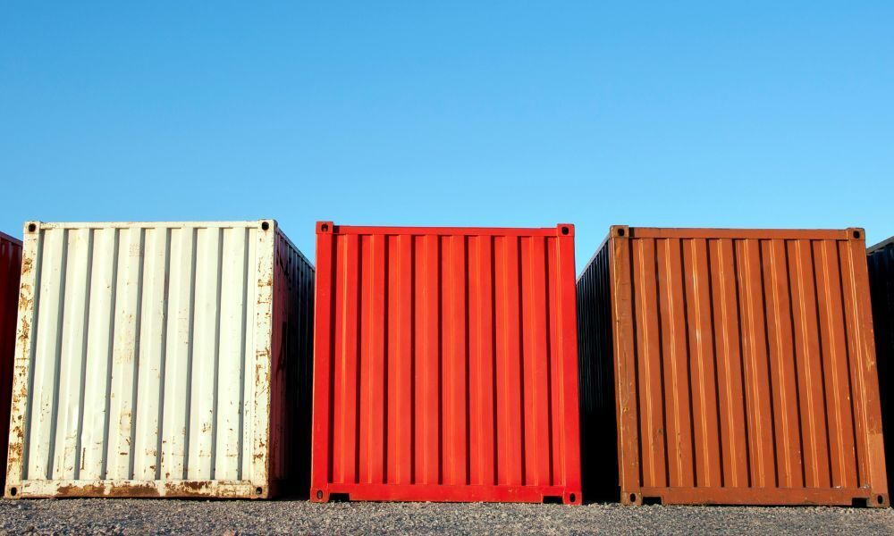 3 shipping containers of different grades side by side