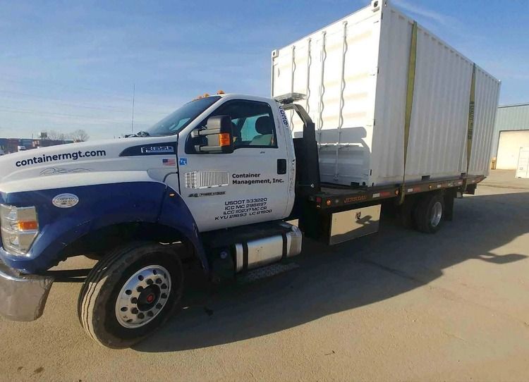 truck with a shipping container loaded on the back
