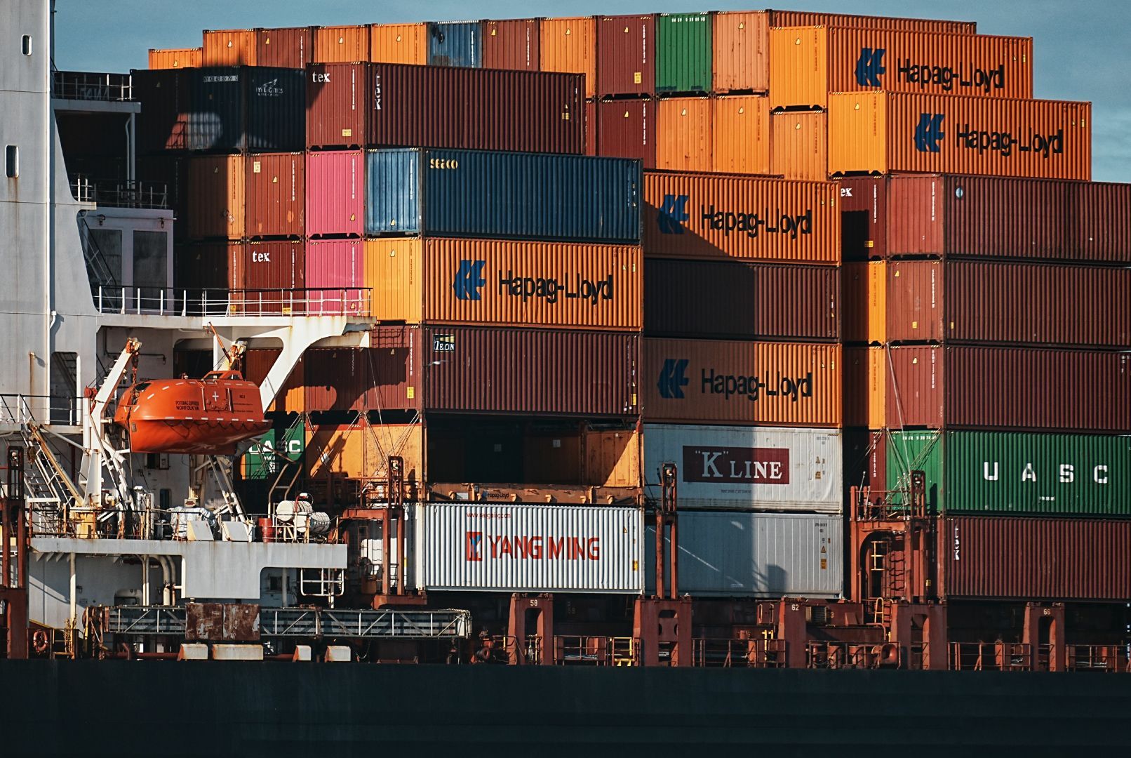 Stack of shipping containers on a ship with brand names