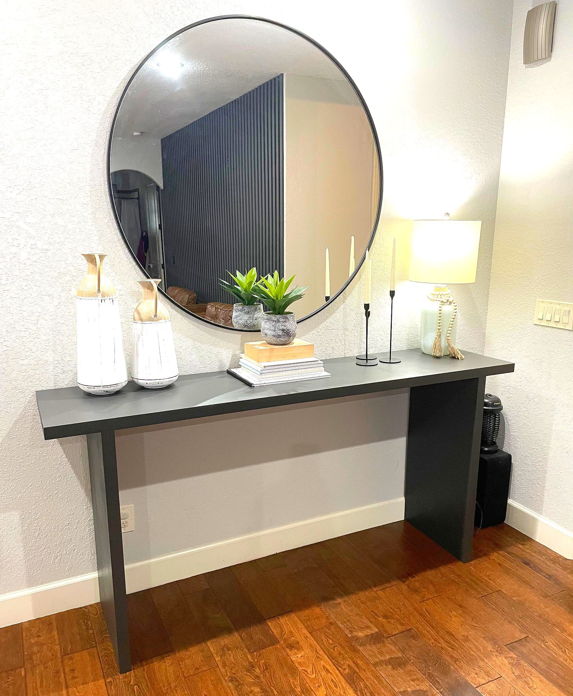 A table with a round mirror on top of it