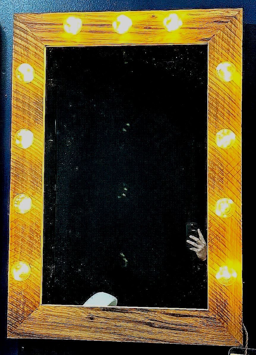 A picture frame with a hand sticking out of it