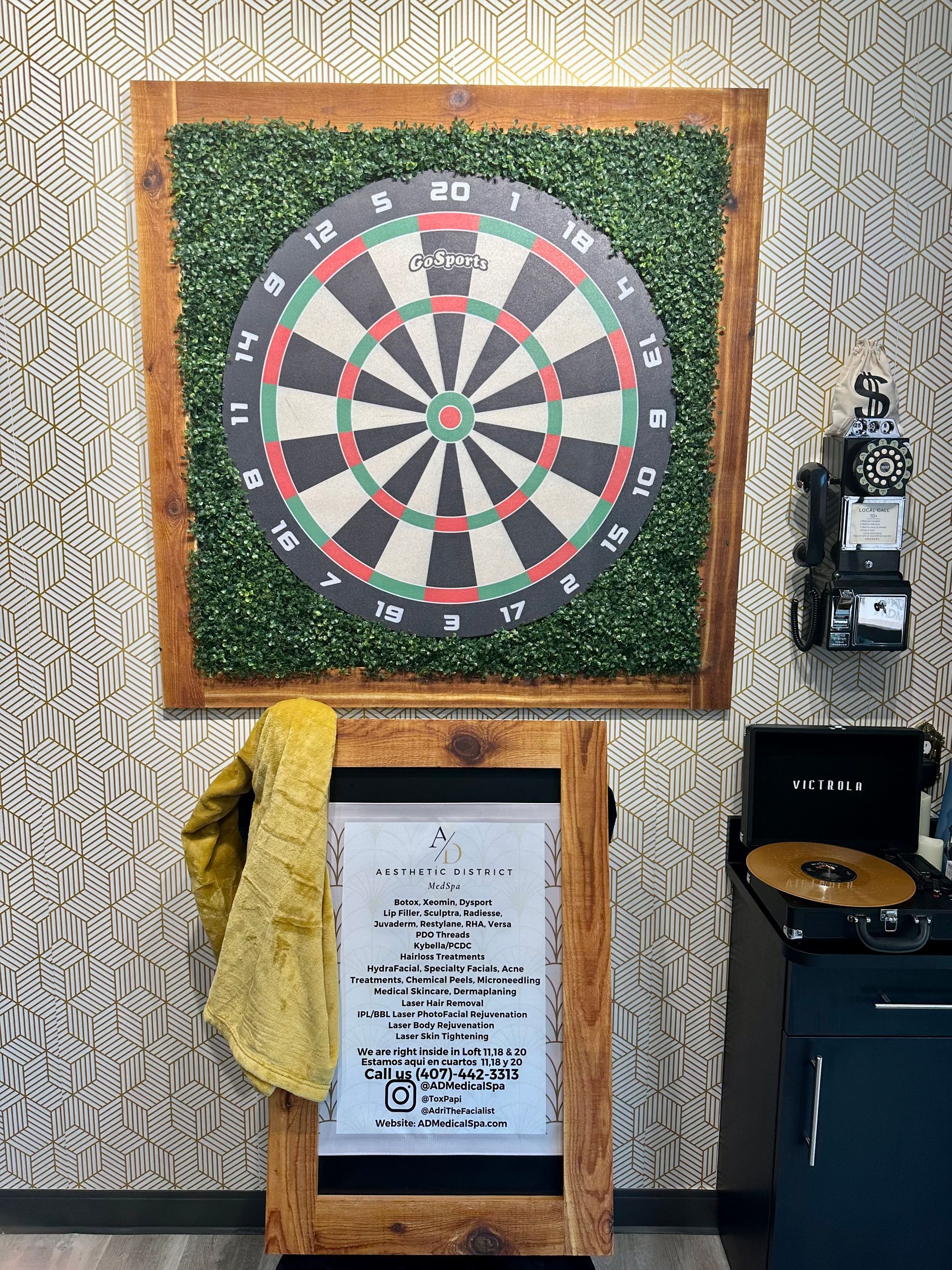 A dart board is hanging on a wall in a room.