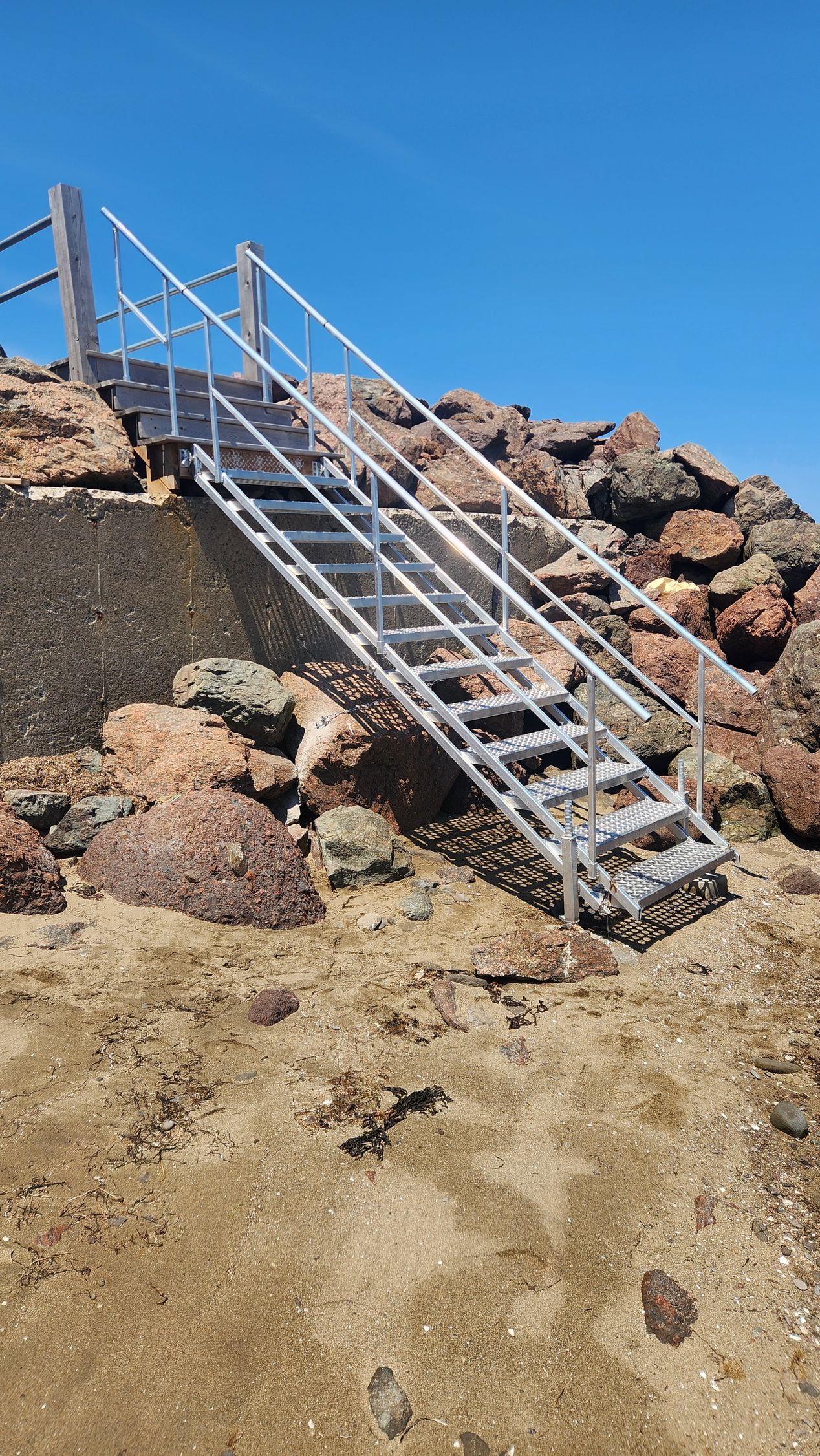 A set of stairs leading up to a rocky hill.