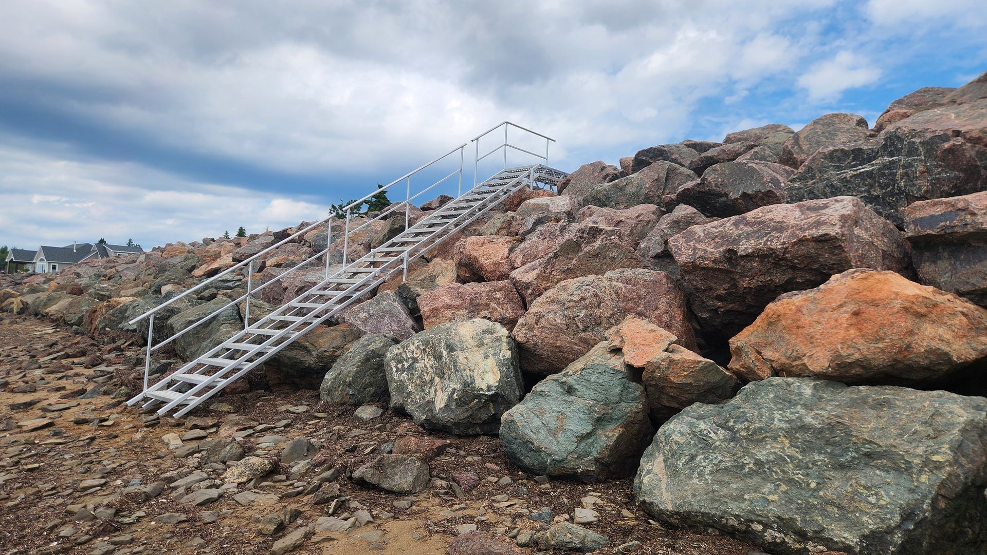 A ladder is sitting on top of a pile of rocks.
