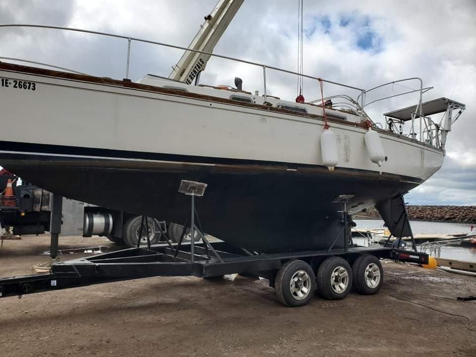 A boat is on a trailer with a license plate that says tc 3674