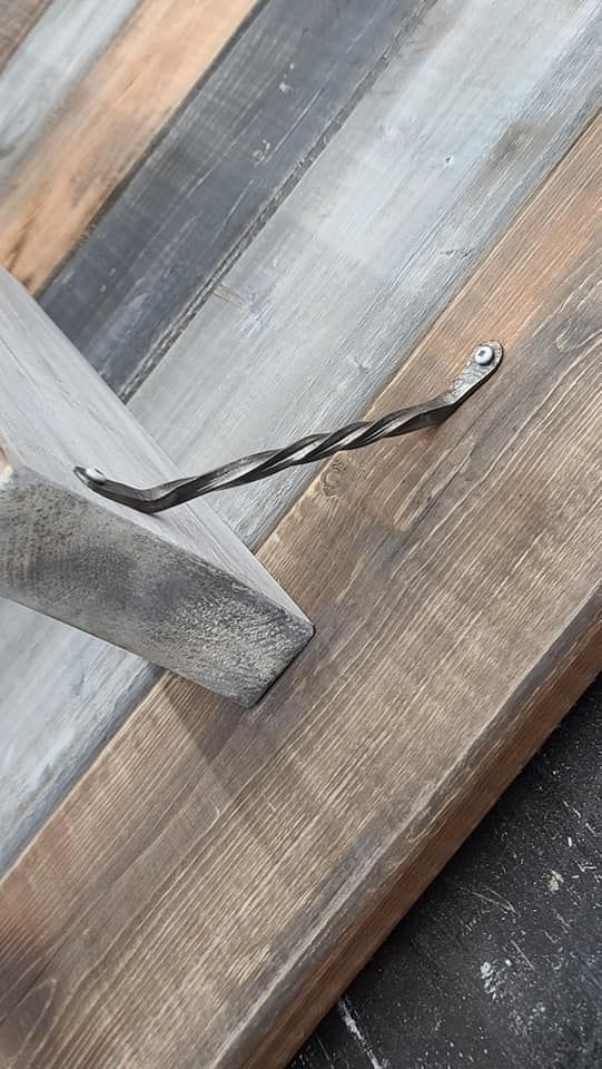 A close up of a piece of wood with a screw in it.