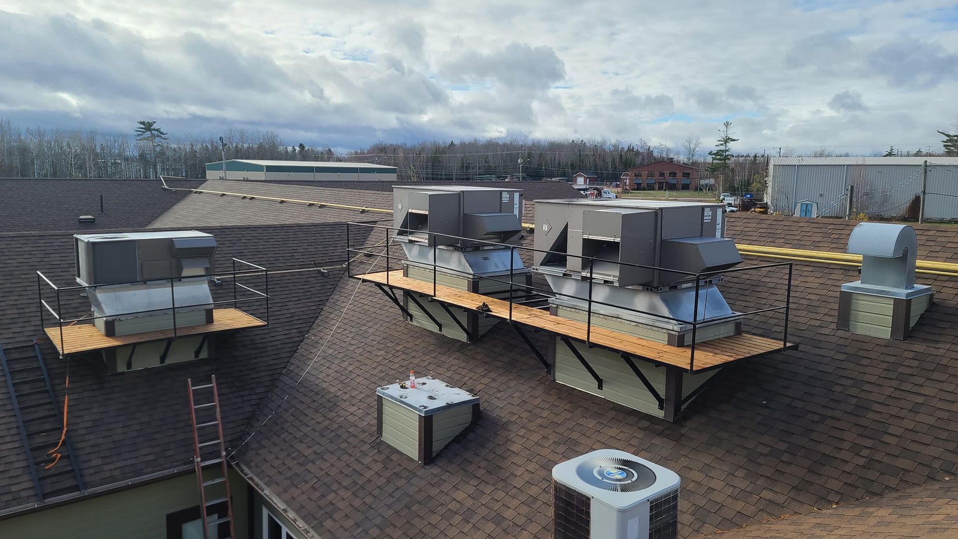 A roof with a lot of air conditioners on it
