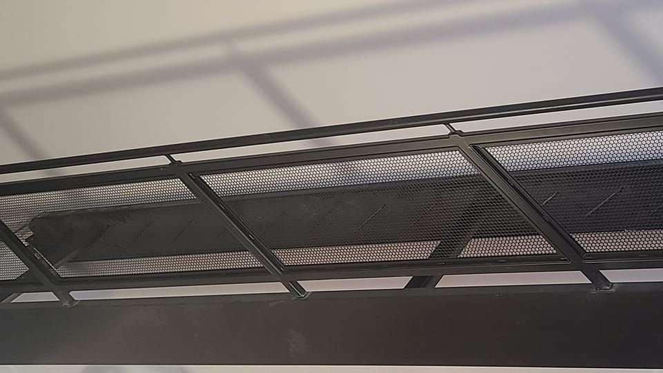 A close up of a metal railing on a bridge