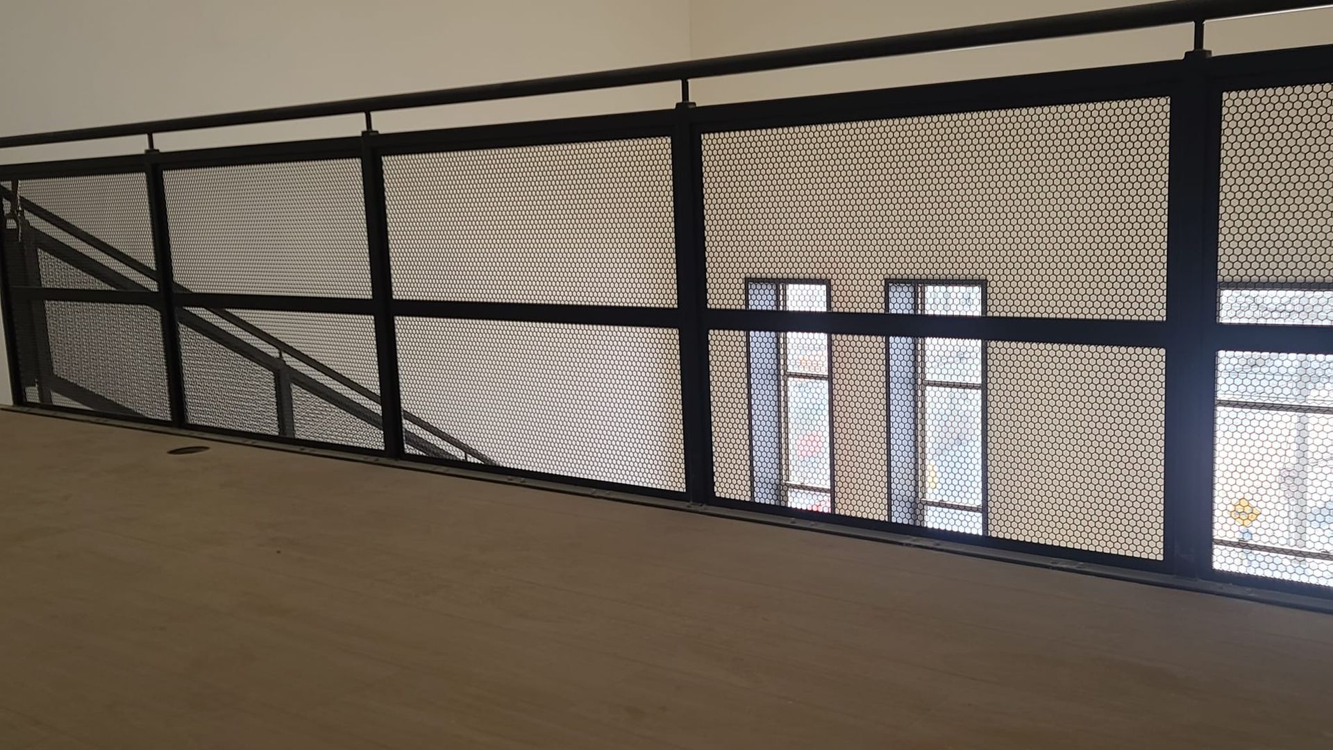 A balcony with a metal railing and a window.