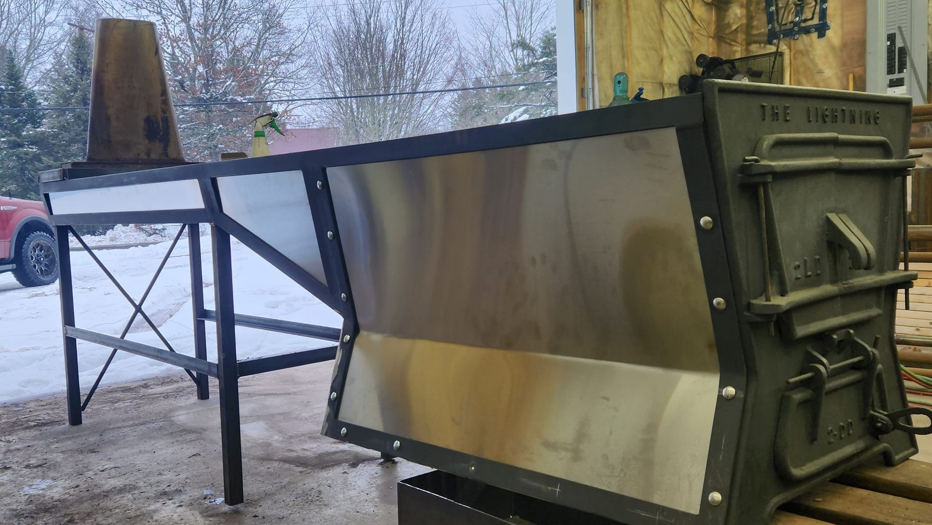 A large metal box is sitting on top of a wooden table.