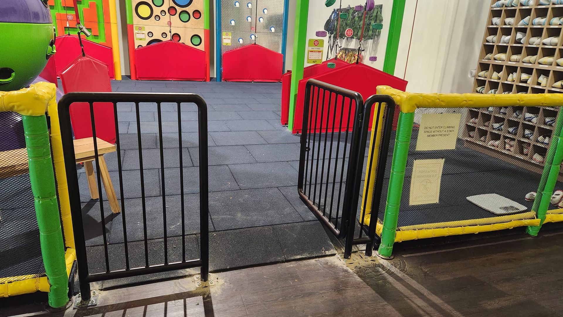 There is a fence in the middle of a playground.