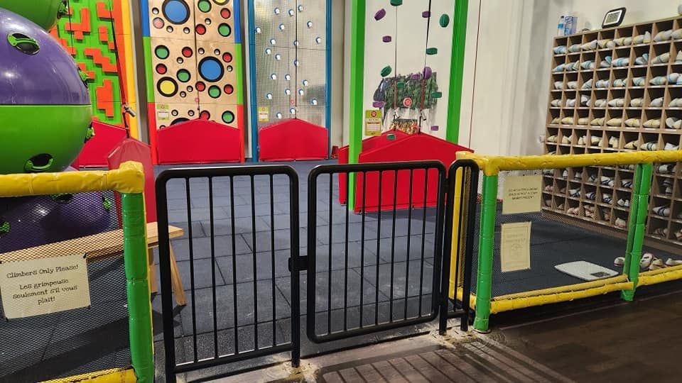 There is a fence in the middle of a playground.