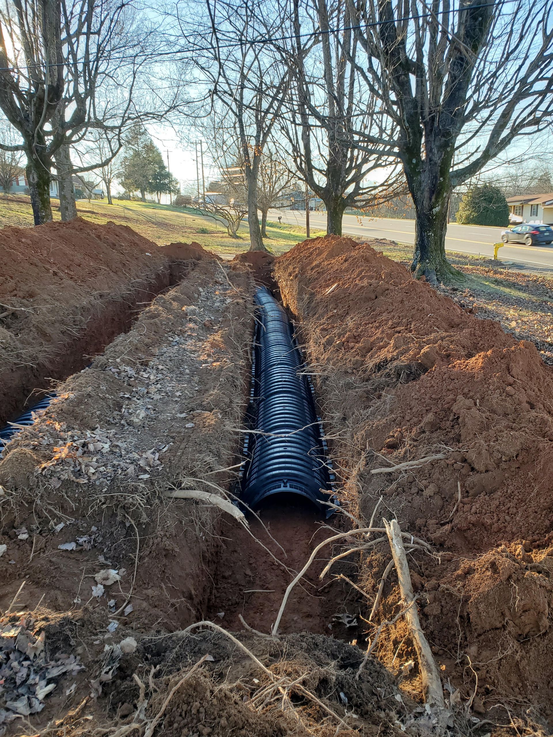 A large pipe is being installed in a hole in the ground.