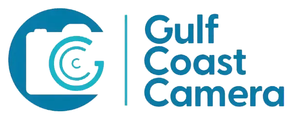 a logo for gulf coast camera shows a camera in a blue circle