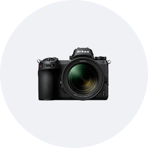 a nikon camera is sitting on top of a white circle .