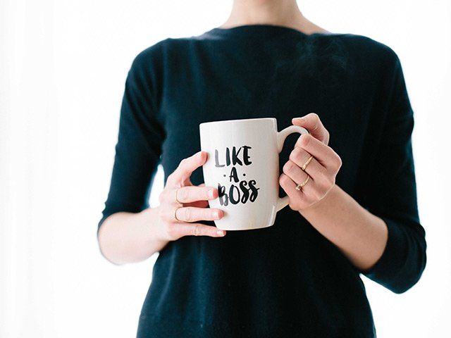 a woman holding a mug