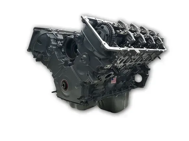 A close up of a motorcycle engine on a white background.