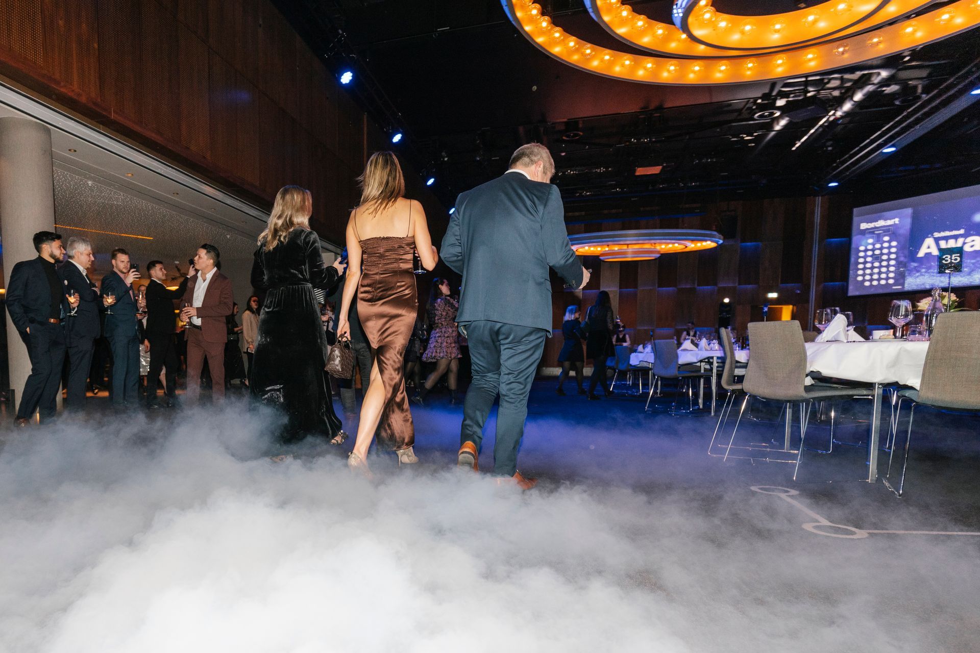 En gruppe mennesker går gjennom et rom fylt med røyk.