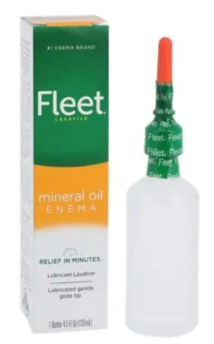 Fleet mineral oil enema box and applicator bottle with orange cap on white background