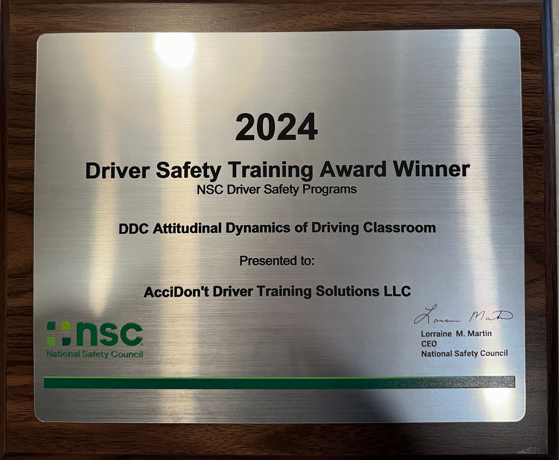 A man is sitting at a table using a laptop computer.