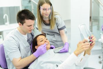 A Dentist and Assistant in a Clinic Help a Patient Check Their Teeth — Killara Dental in East Killara, NSW