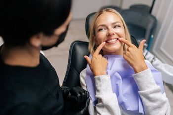 A Person in a Dental Chair Points to Their — Killara Dental in East Killara, NSW