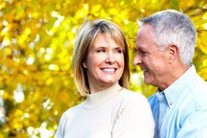A Person With Shoulder-length Hair and a Light Sweater Smiles — Killara Dental in East Killara, NSW