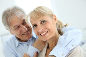 A Person Smiling While Being Embraced From Behind by Another Person — Killara Dental in East Killara, NSW