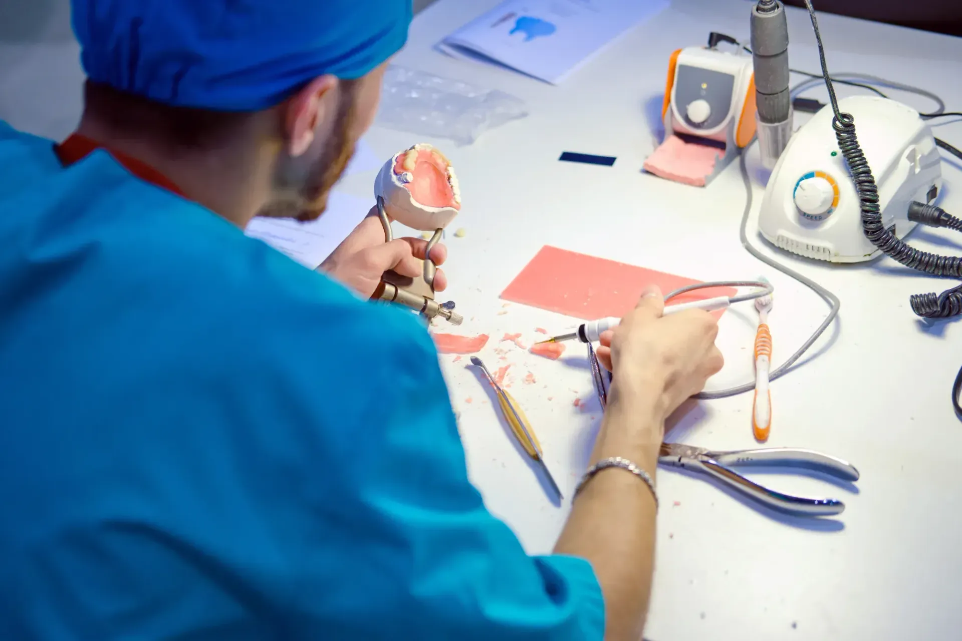Person in Blue Cap Working With Dental Tools in a Clinical Workspace — St. Ives Dental Boutique In Macquarie Park, NSW