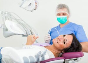 A Smiling Patient in a Dental Chair Gives a Thumbs Up — Killara Dental in East Killara, NSW